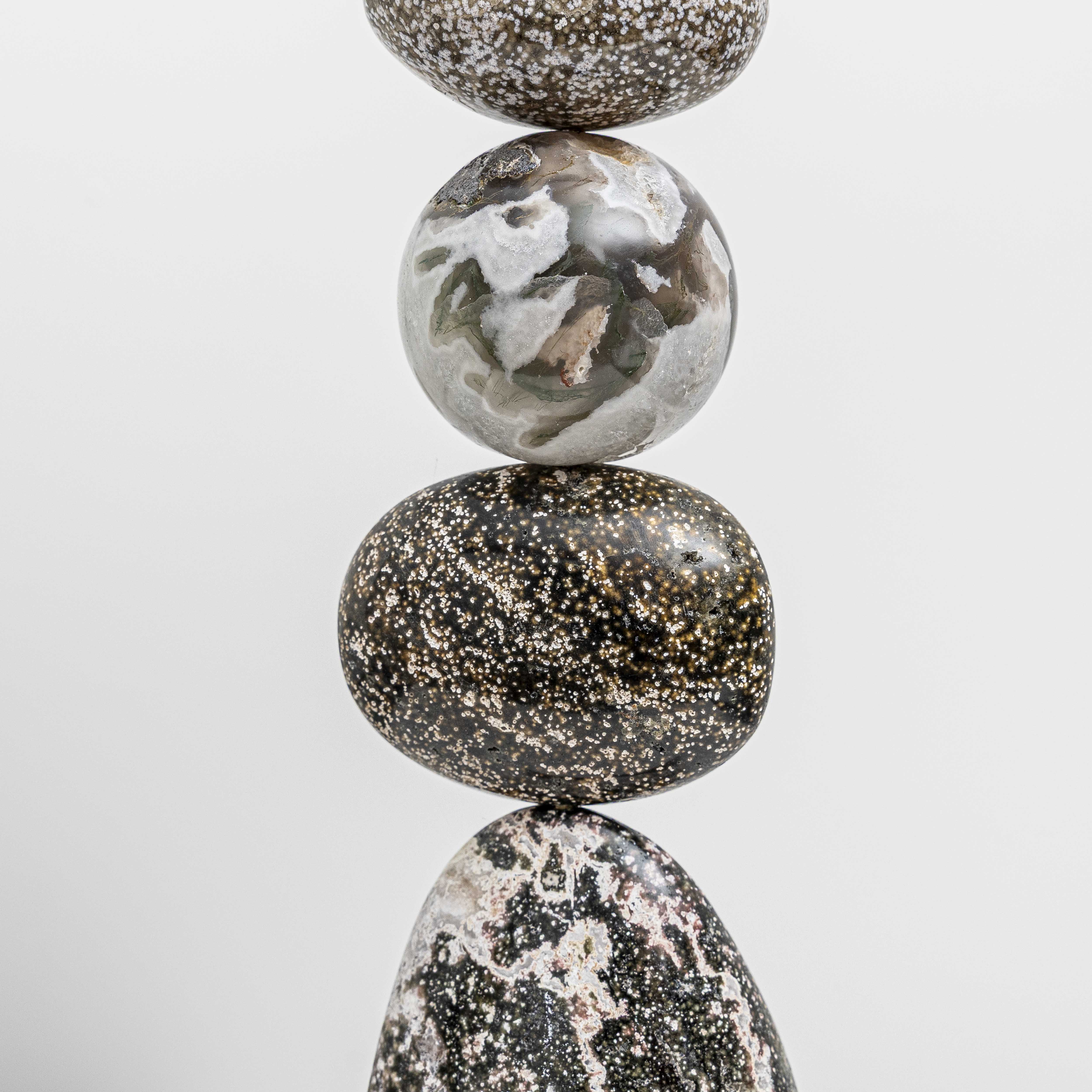 Close up of Pyrite foam, Ocean Jasper, a Moss Agate sphere, Ocean Jasper oval forms, part of Celia Lindsell's artworks, at Shop Kit Kemp. 