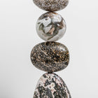 Close up of Pyrite foam, Ocean Jasper, a Moss Agate sphere, Ocean Jasper oval forms, part of Celia Lindsell's artworks, at Shop Kit Kemp. 