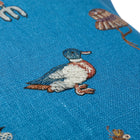 Close up of Garden Shed blue cushion with hand embroidered duck detail. Exclusively at Shop Kit Kemp.