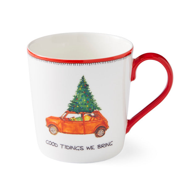 Featuring a Christmas-themed illustration of a car with a Christmas tree and presents on the roof, along with the text 'Good Tidings We Bring', this mug is a perfect present for any tea or coffee connoisseur or Christmas gift.