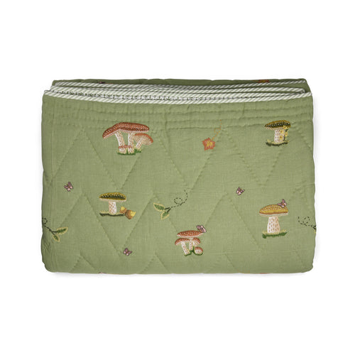Good Trip Quilted Bedspread in Green from the Weekend Collection by Kit Kemp x Chelsea Textiles, crafted from quilted linen with embroidered woodland motifs and a beautifully bound finish.