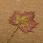 Close up of Good Trip yellow cushion with hand embroidered leaf detail. Exclusively at Shop Kit Kemp.