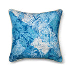 Statement cushion in Kit Kemp's Harlequin River Bank printed linen-blend fabric. The pattern is a layered blue and white patchwork of florals and geometric scrolls with a soft, watery texture.