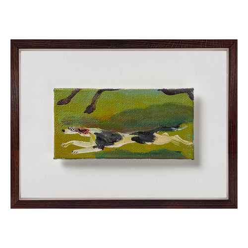 A horizontal format allows this hound’s body to stretch fully into its stride. Painted in oil with brisk, visible strokes, the dog runs low across a sweep of green landscape, its lean form cutting cleanly through the field. A darker silhouette above hints at the presence of a horse without fully resolving it, creating a layered sense of space and pace. The narrow proportions emphasise speed and direction, while the restrained palette keeps the composition grounded. Exclusively at Shop Kit Kemp.
