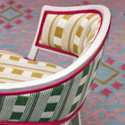 Whitby chair and jelly roll rug with geometric pattern designs, handwoven by skilled artisans using wool and cotton into a statement piece that offers striking colour combinations and a warm and welcoming style. 