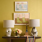Kit Kemp desk with Sister Lamps and pictures on the wall by Jo Waterhouse