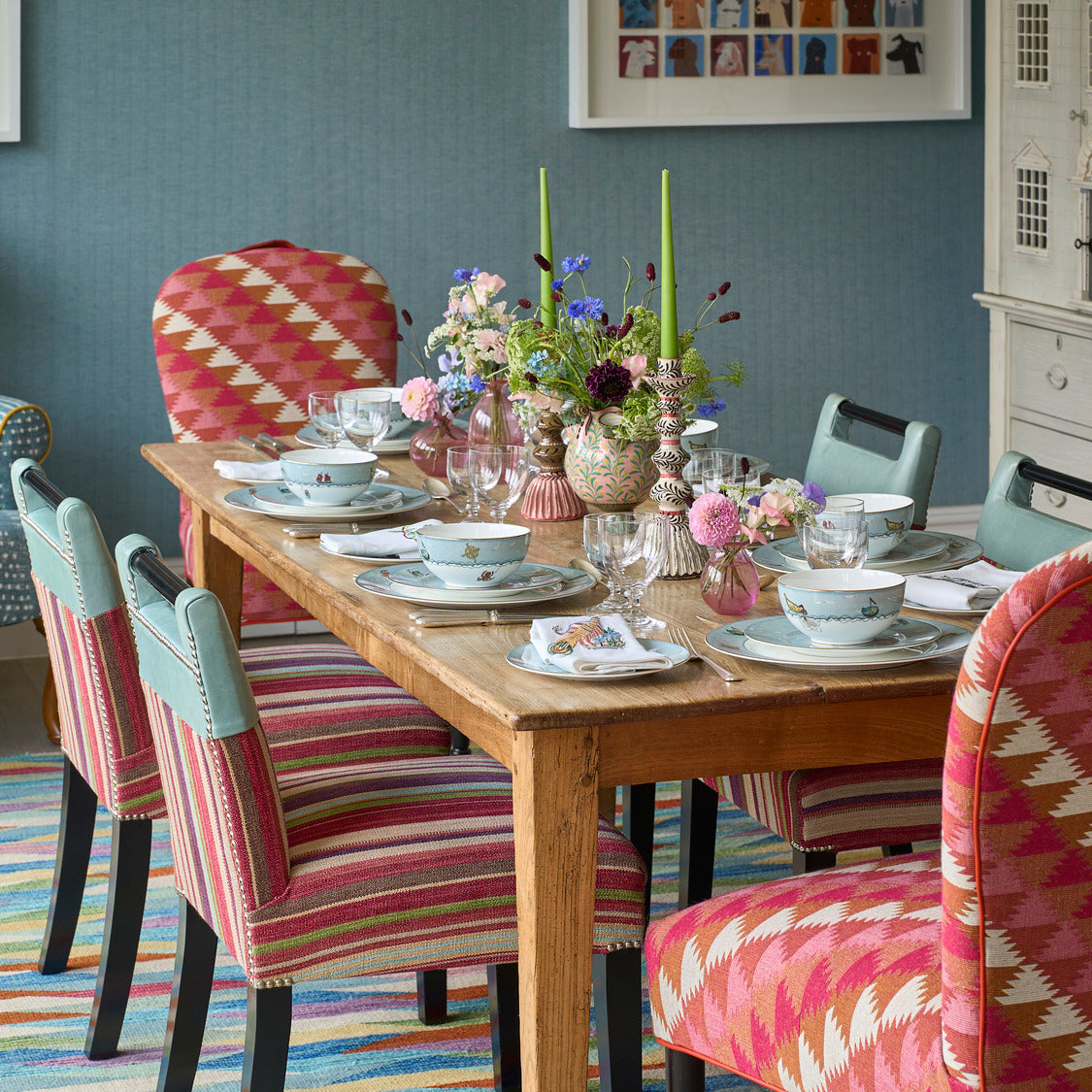 Susan Chairs in Busy Lizzie fabric bookend the Sailor's Farewell tableware display, with Handle chairs on either side to complete the dining setting. 