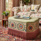 Kit Kemp Hexagon ottoman upholstered in found fabric with a Melissa sofa upholstered in Knights tale in the background