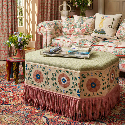Kit Kemp Hexagon ottoman upholstered in found fabric with a Melissa sofa upholstered in Knights tale in the background