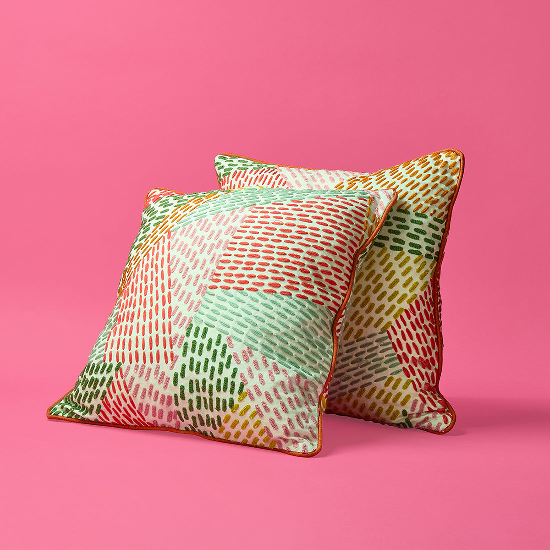 Kit Kemp Design Studio cushion in Pierre Frey fabric Miwork with hand embroidered dashed lines and contrasting pink pipe edge