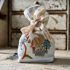 Embroidered Lavender bag sitting on a vintage dressing table 