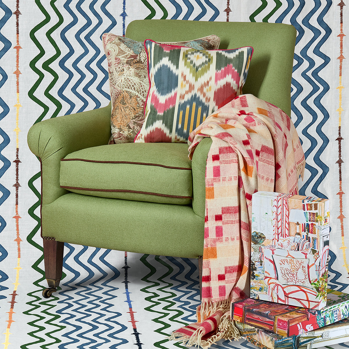 Yin Ikat fabric cushion with red piping, exclusively at Shop Kit Kemp. Layer with Harlequin cushion and Brick Weave throw, and gifting jigsaw designs inspired by the Firmdale hotels. 