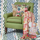 Yin Ikat fabric cushion with red piping, exclusively at Shop Kit Kemp. Layer with Harlequin cushion and Brick Weave throw, and gifting jigsaw designs inspired by the Firmdale hotels. 