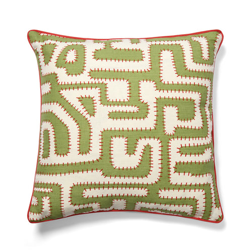 Decorative pillow with green and white geometric pattern on a white background