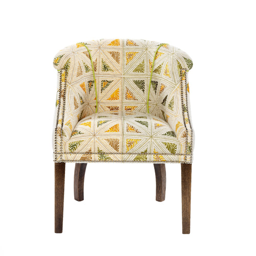 A Min Tub Chair upholstered in yellow and green fabric 