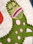 Mythical Gherkin applique made with colour wool and applied on Kit Kemp cushions and furniture.