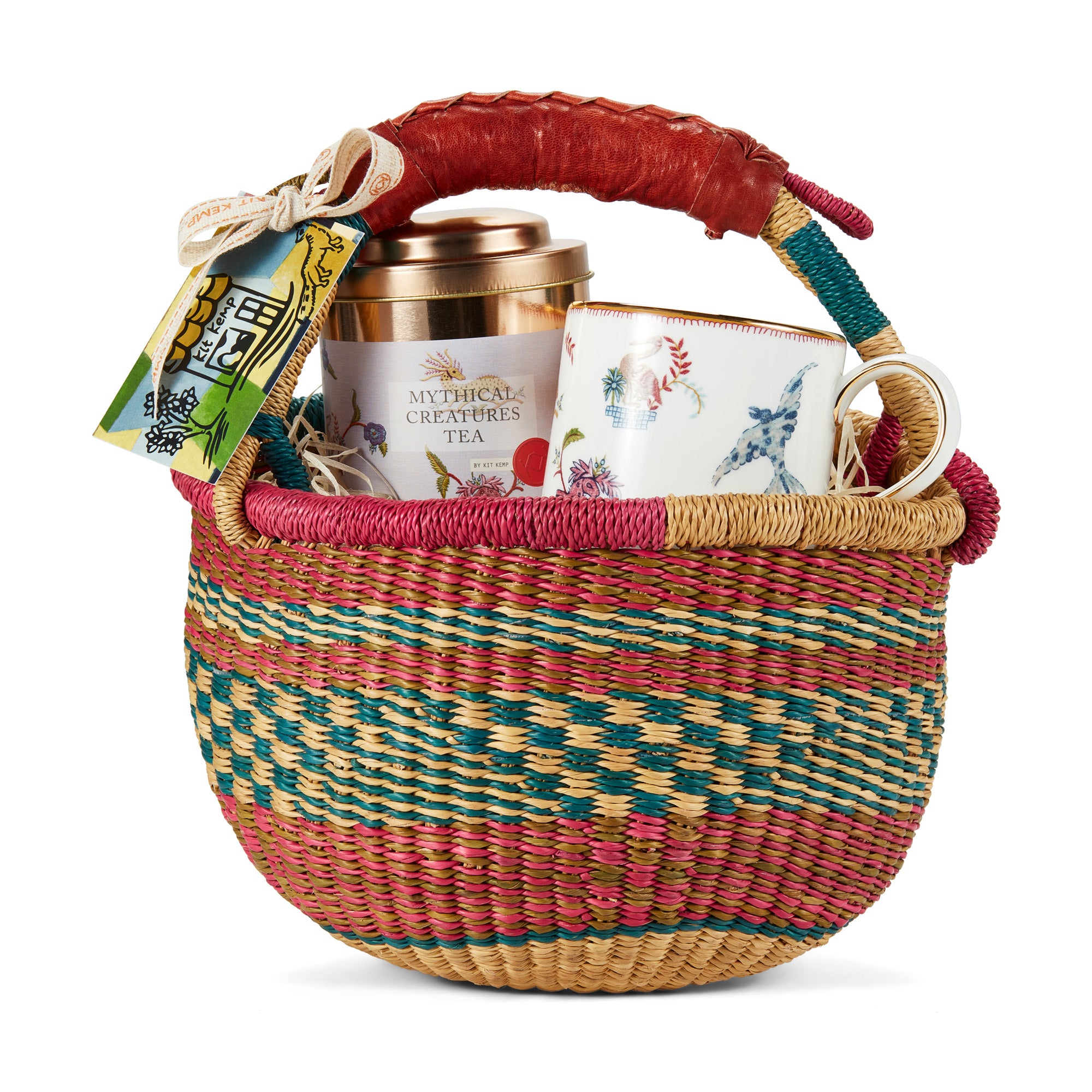 Mythical Creatures Tea set is presented in a colourful woven basket with a leather handle, containing a tin of Mythical Creatures tea caddy tin, and a ceramic mug with a Mythical Creatures design. 