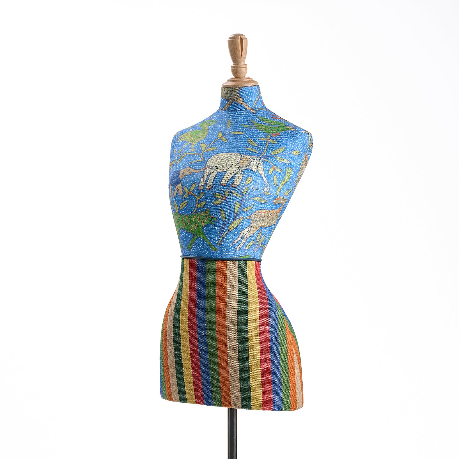 The Noah's Ark Mannequin is dressed in a striking blue Noah's Ark and Tim's Rug Jewel fabrics, adorned with animal motifs and stripes, paired with leather piping at the waist.