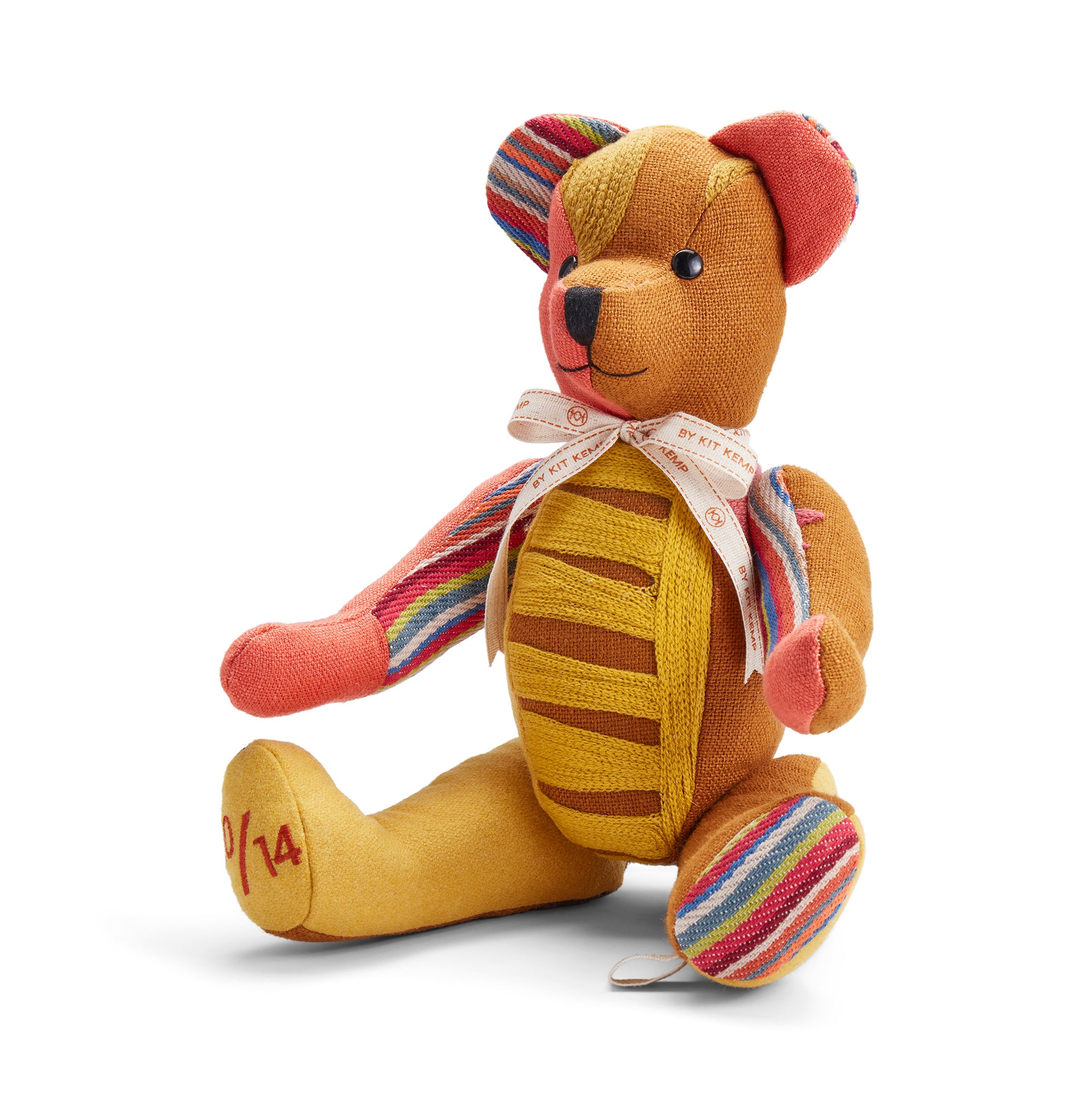A vibrant, special-edition Willow Bear crafted from an eclectic mix of high-quality fabrics. The design blends warm ochre tones with jewel-toned green and pink accents, emphasizing the tactile, handcrafted nature of this Kit Kemp Design Studio creation.