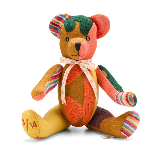 A one-of-a-kind Large Willow Bear from Kit Kemp’s Patchwork Collection, handmade in the UK. The bear features a rich ochre body with bespoke patchwork details in emerald green and coral, showcasing the premium texture of repurposed designer fabric offcuts.