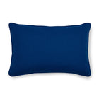 The reverse of the Ondine Mediterranean cushion is a bold, solid royal blue, matching the decorative piping, which perfectly frames the vibrant saffron and floral print.