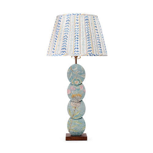 The Papillon Flower Lamp features a handmade timber base with a four-disc design, hand-painted by artist Melissa White. Inspired by the Papillon wallpaper, each lamp is one of a kind, with details varying slightly due to its hand-painted nature. Paired with Wriggle Room gathered fabric lampshade in Blue / Yellow tones.