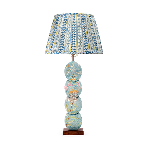 The Papillon Flower Lamp features a handmade timber base with a four-disc design, hand-painted by artist Melissa White. Inspired by the Papillon wallpaper, each lamp is one of a kind, with details varying slightly due to its hand-painted nature. Paired with Wriggle Room gathered fabric lampshade in Blue / Yellow tones.