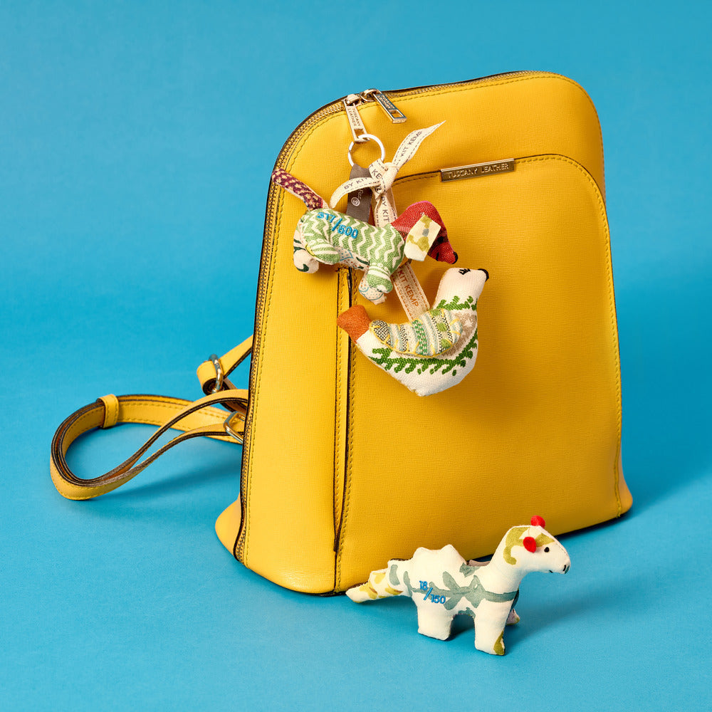Patch work key rings attached to a yellow leather ruck sack.