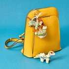 Patch work key rings attached to a yellow leather ruck sack.