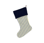 A blue and yellow striped Christmas stocking with a blue cuff, custom made with Christopher Farr fabric created by Kit Kemp.