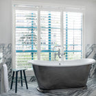 Pixie side table featured in Firmdale hotel bathroom, a perfect addition next to bath to hold essential and decorative items.