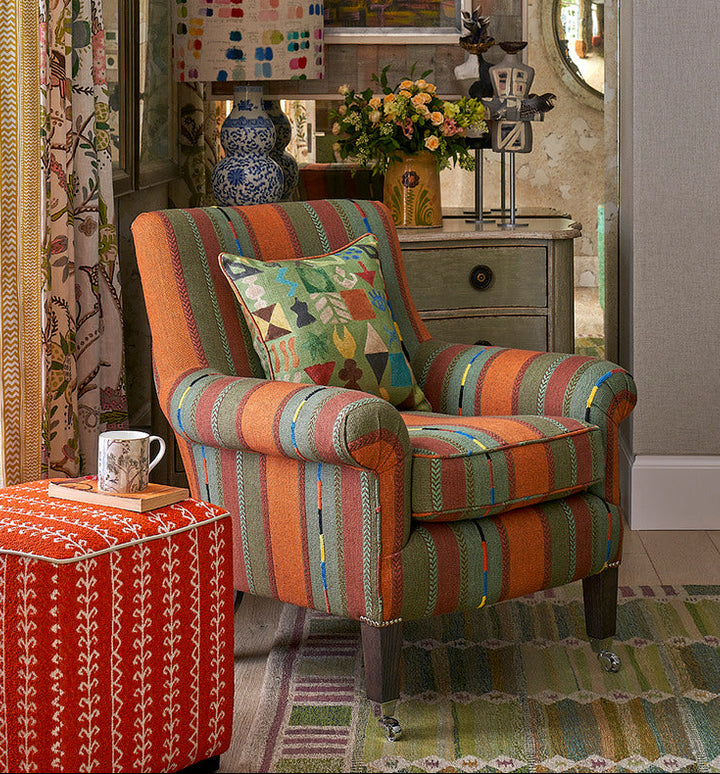 Potato print cushion in green, paired with Leo chair in Bunty fabric, designed by Kit Kemp. Little Weed cube stool in foreground with Tall Trees mug.