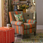 Potato print cushion in green, paired with Leo chair in Bunty fabric, designed by Kit Kemp. Little Weed cube stool in foreground with Tall Trees mug.