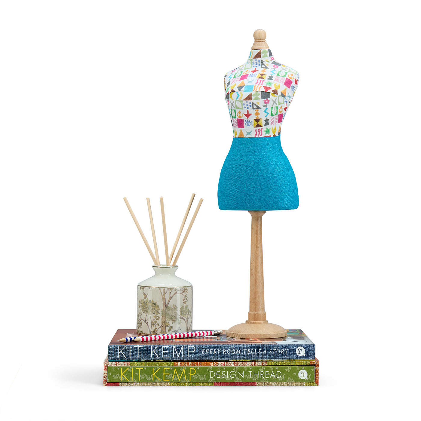 Hand-crafted mini mannequin dressed in a bold, multi-coloured Potato Print folk-art fabric bodice and a contrasting textured blue skirt. A distinctive collector's piece and signature feature in luxury interiors.