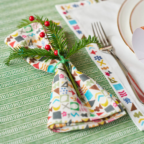 Decorative festive arrangement with potato print napkin, placemat and tableware by Shop Kit Kemp.