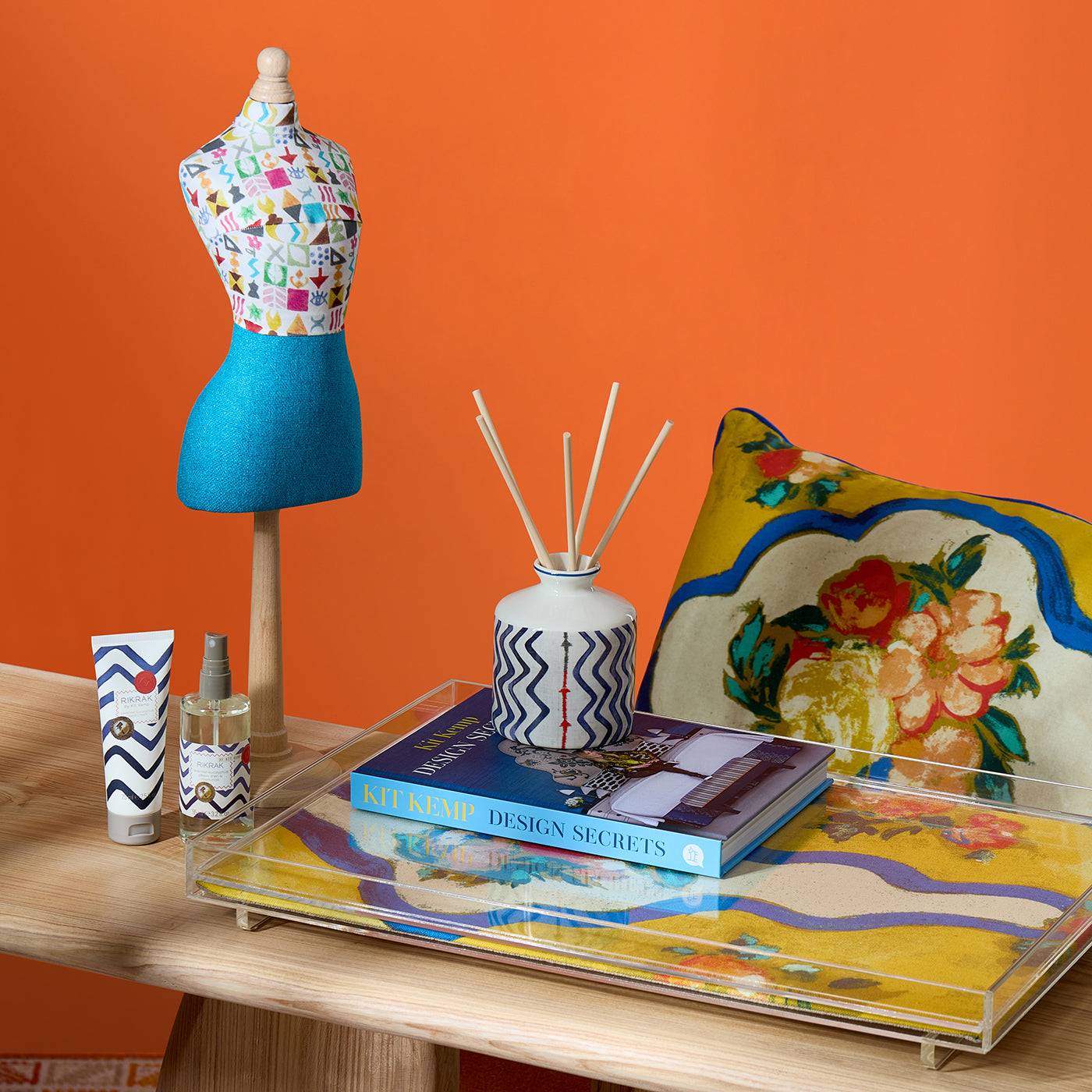 A perfect gift for any Kit Kemp fan, the Potato Print mini mannequin is statement piece at desk side, or on mantelpiece. Grouped with Rik Rak home fragrances, and striking blue and yellow cushion and tray, it's a joyful accessory to elevate home decor.