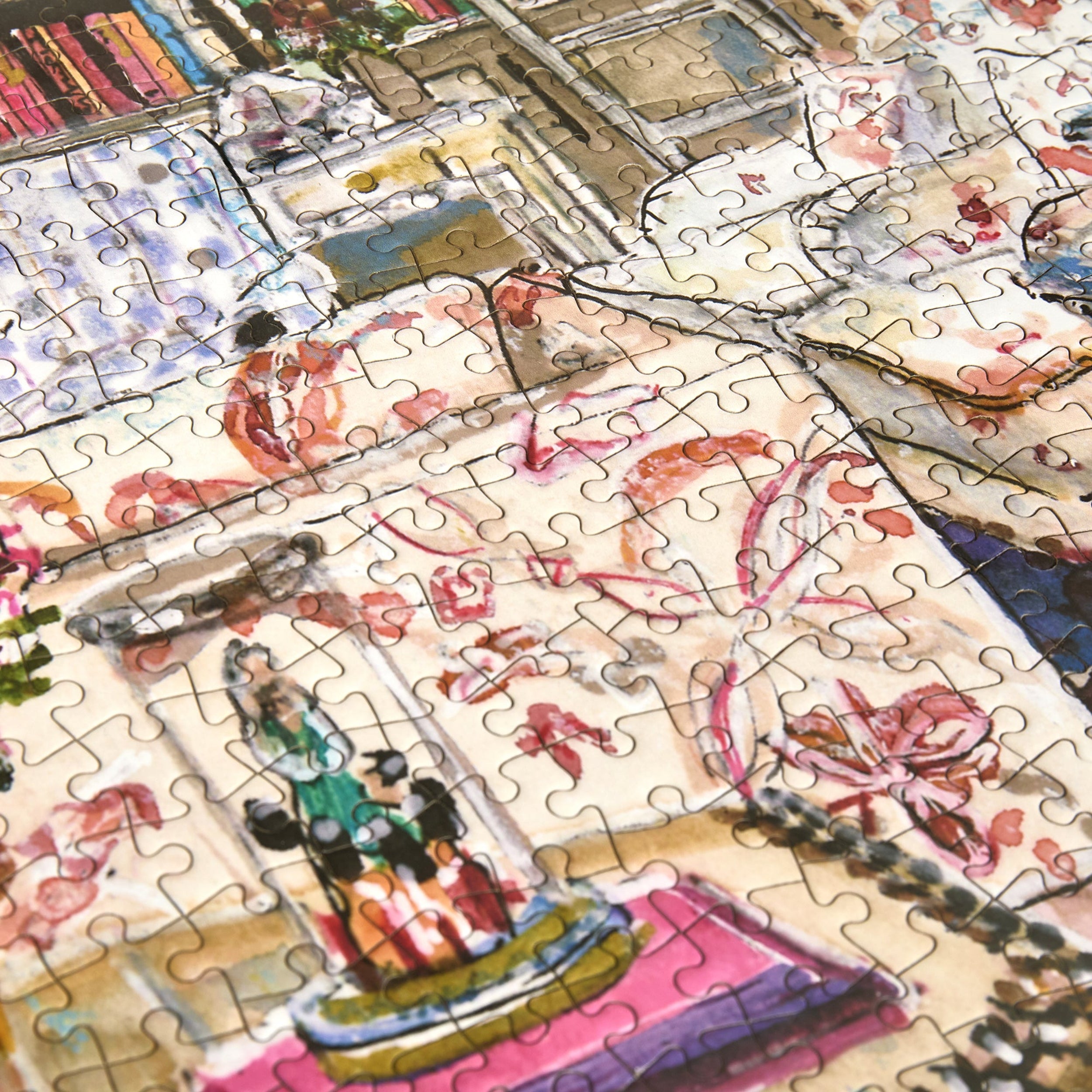 Partial puzzle with colorful artwork featuring people and buildings