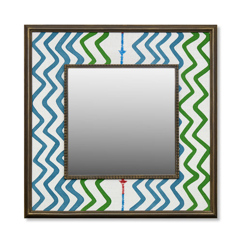 Featuring Kit's 'Rick Rack' with screen printed zigzag lines and embroidery on linen, this wonderful decorative mirror feature a design full of movement and joy with its wide fabric-covered border surrounding a square central mirror in a wooden frame.