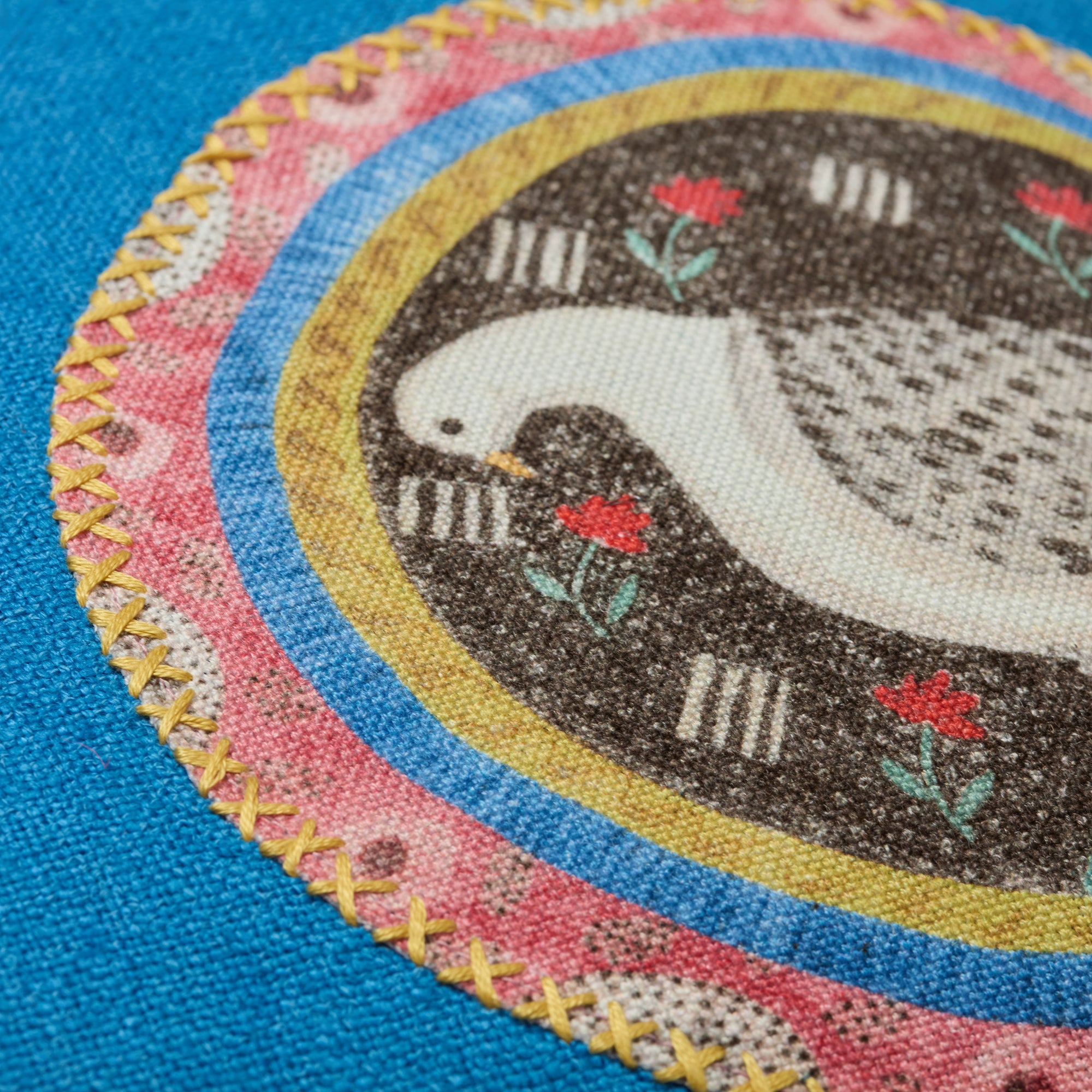 Kit Kemp Design Studio cushion in blue linen texture, mixing two animal appliqués from the Robina's Dinner Party collection with patterned piping. Every cushion is one-of-a-kind.