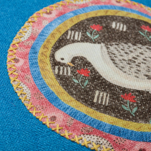 Kit Kemp Design Studio cushion in blue linen texture, mixing two animal appliqués from the Robina's Dinner Party collection with patterned piping. Every cushion is one-of-a-kind.