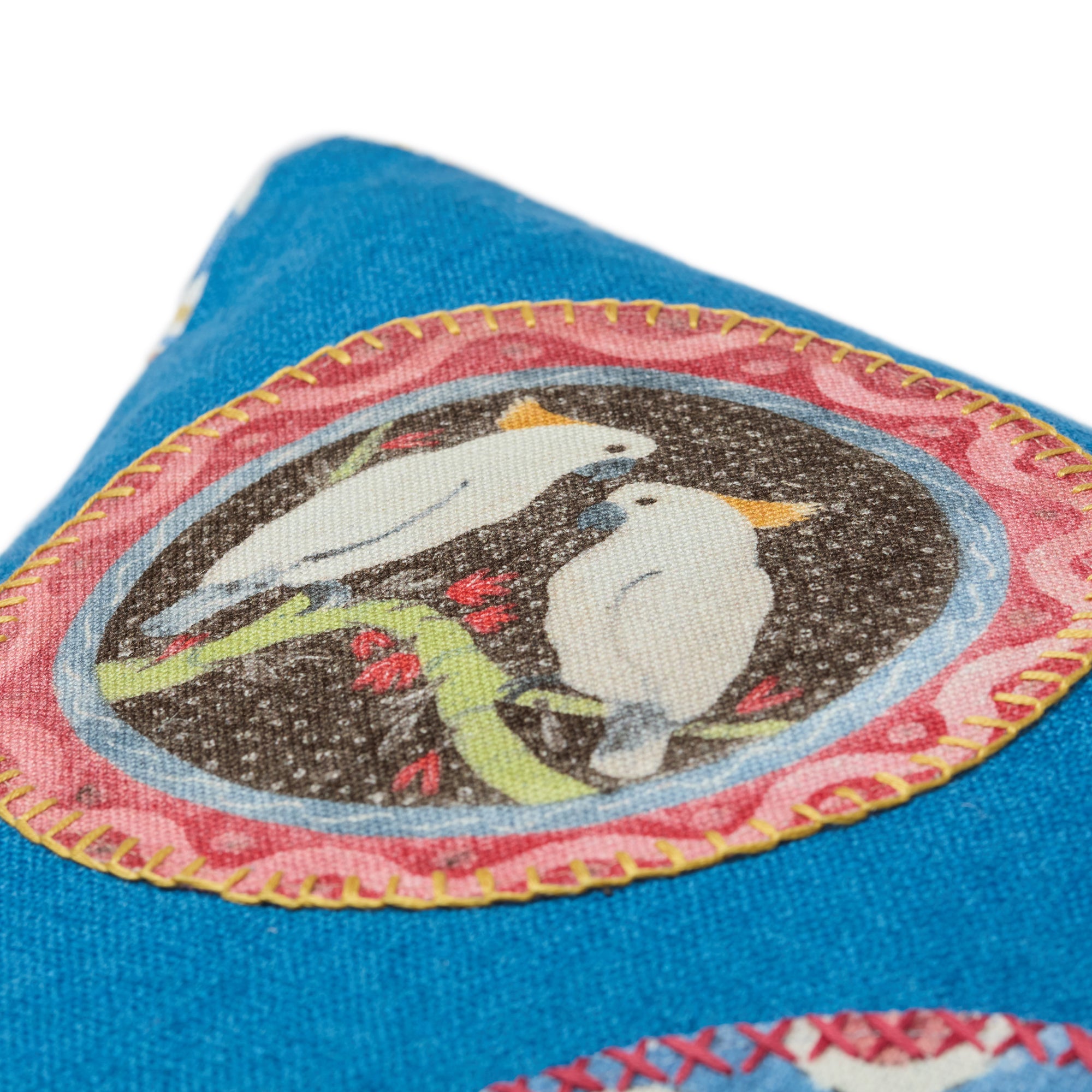 Artisanal Kit Kemp cushion in vibrant blue linen, mixing two hand-finished animal appliqués from the Robina's Dinner Party collection. Characters vary from birds to cats and rabbits, ensuring a bespoke design for each piece.