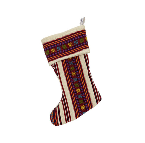A richly textured Christmas stocking featuring the unique Romany Weave in Ruby design, with vibrant stripes and embroidered details in festive reds, oranges, and purples against a cream background. Perfect for luxurious festive gifting and adding a handcrafted, Kit Kemp touch to holiday decor.