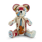 A special edition Ruby Willow Bear celebrating Firmdale’s Ruby Anniversary, featuring intricate patchwork designed by Kit Kemp. The bear is adorned with decorative red pom-pom beading along the edges of its ears and paws, highlighting its premium, celebratory craftsmanship.