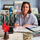 SJ Alexeby illustration artist sitting at her desk painting 