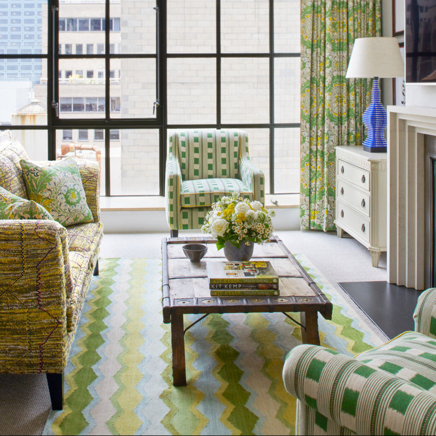 Green tones interior grounded with Safety Net Green Rug by Kit Kemp design for Firmdale hotels
