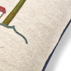 Edge profile of the square wool cushion highlighting the navy blue piped edge and the texture of the British made wool.