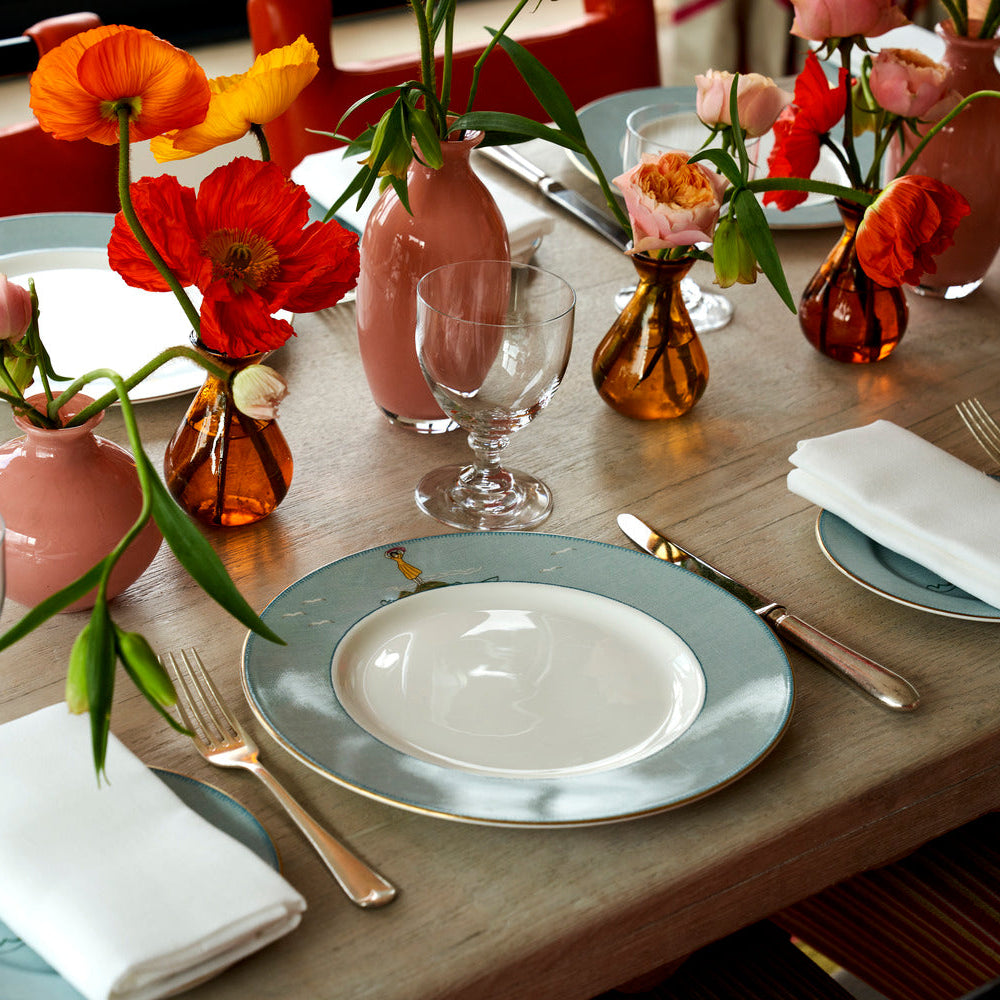 Table setting with Sailor's Farewell fine bone china dinner plate, informal and colourful florals combined with the distinctive blue tableware, featuring delightful sailors, scuba divers, octopus, and woman holding a scarf.