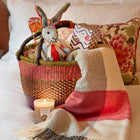Gift set with handmade patchwork rabbit, 100% merino wool checkerboard throw blanket, and iconic lavender and eucalyptus candle presented in a colourful African weave basket, perfect for bedrooms and nurseries, or as a gift to self.