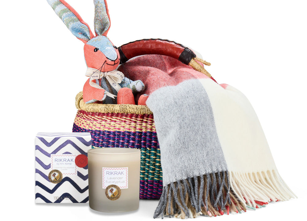 Rabbit patchwork toy, Checkerberry throw, and Lavender Eucalyptus candle in a hand woven basket created by Shop Kit Kemp for festive gifting and Christmas presents.