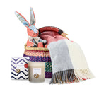 Rabbit patchwork toy, Checkerberry throw, and Lavender Eucalyptus candle in a hand woven basket created by Shop Kit Kemp for festive gifting and Christmas presents.